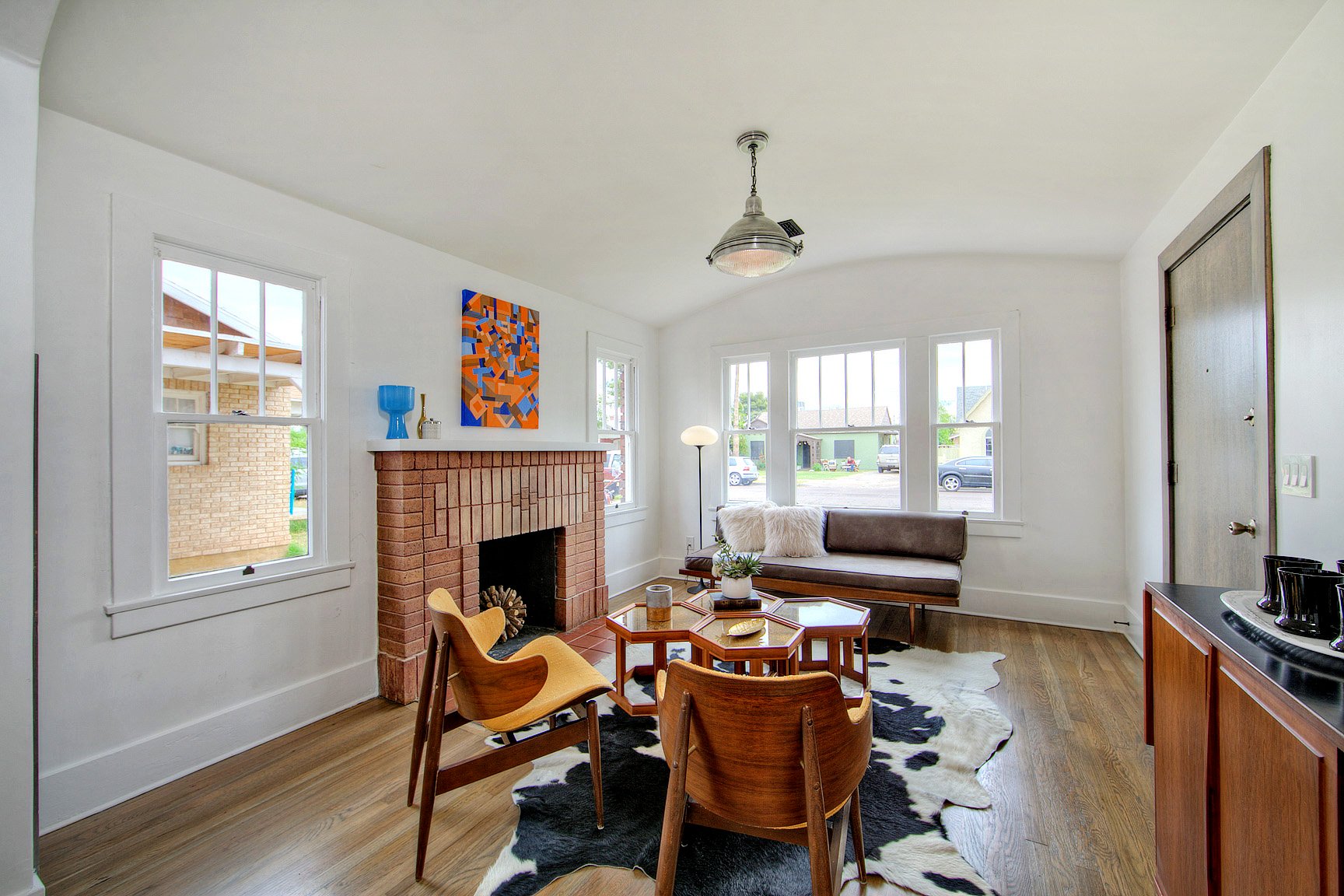Southwestern family room with a fireplace, After a quick house sale for cash