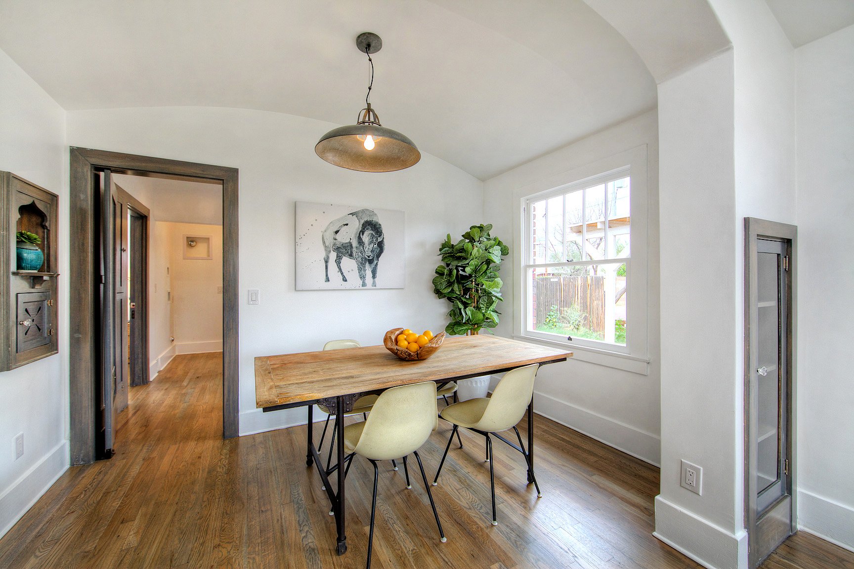 Dining room with vaulted ceiling, built-ins, and wide window